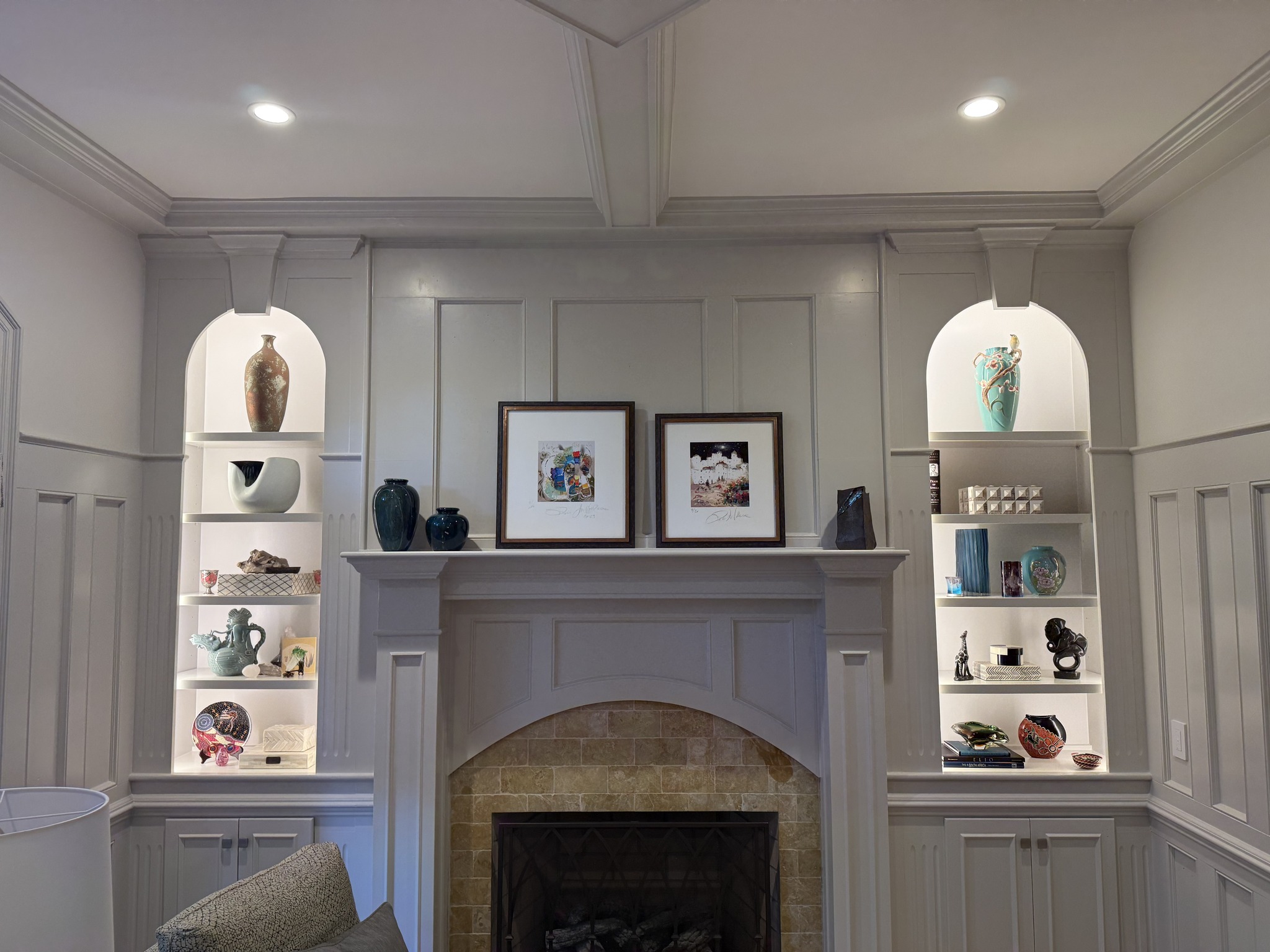 Built-in white shelving with recessed lighting